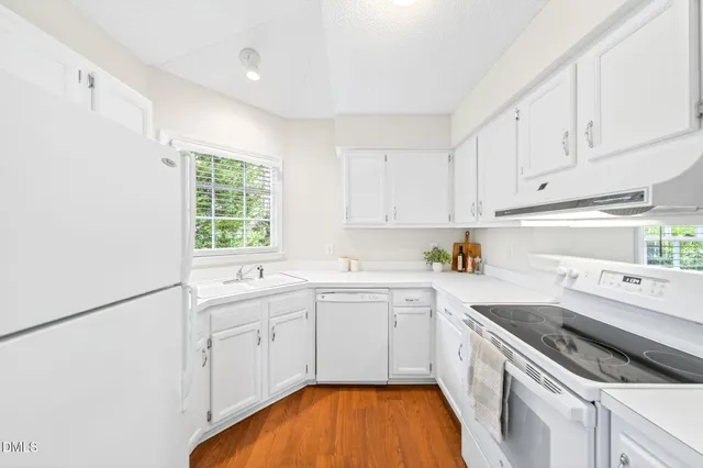 a view of washer and dryer with kitchen in the background