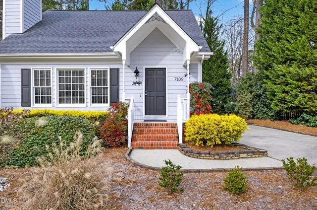 a front view of a house with a yard and outdoor seating