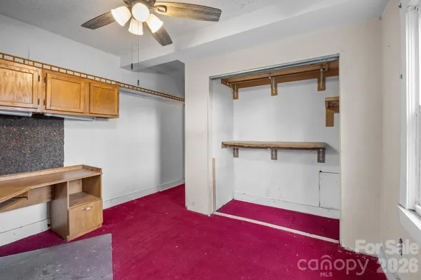 a kitchen with a stove a sink and cabinets