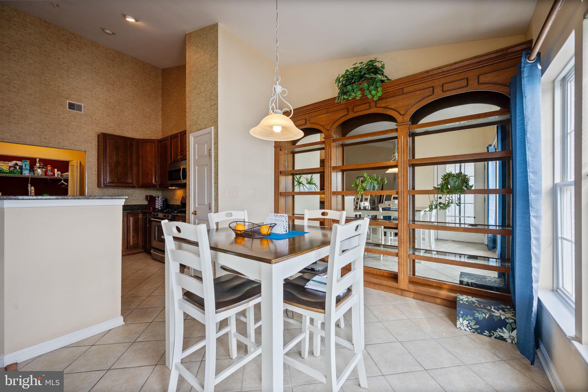 2602 Clarion Court, Unit 404 Odenton, MD 21113 - Photo 12 of 38 a view of a dining room with furniture a kitchen and a chandelier