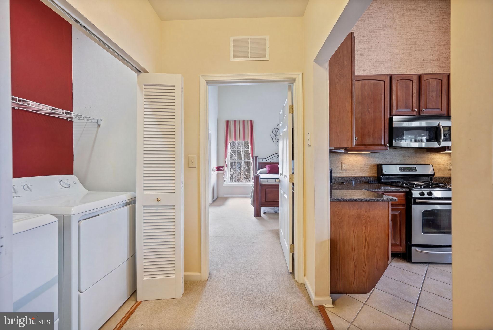 2602 Clarion Court, Unit 404 Odenton, MD 21113 - Photo 14 of 38 a view of a kitchen with a stove fridge and wooden floor