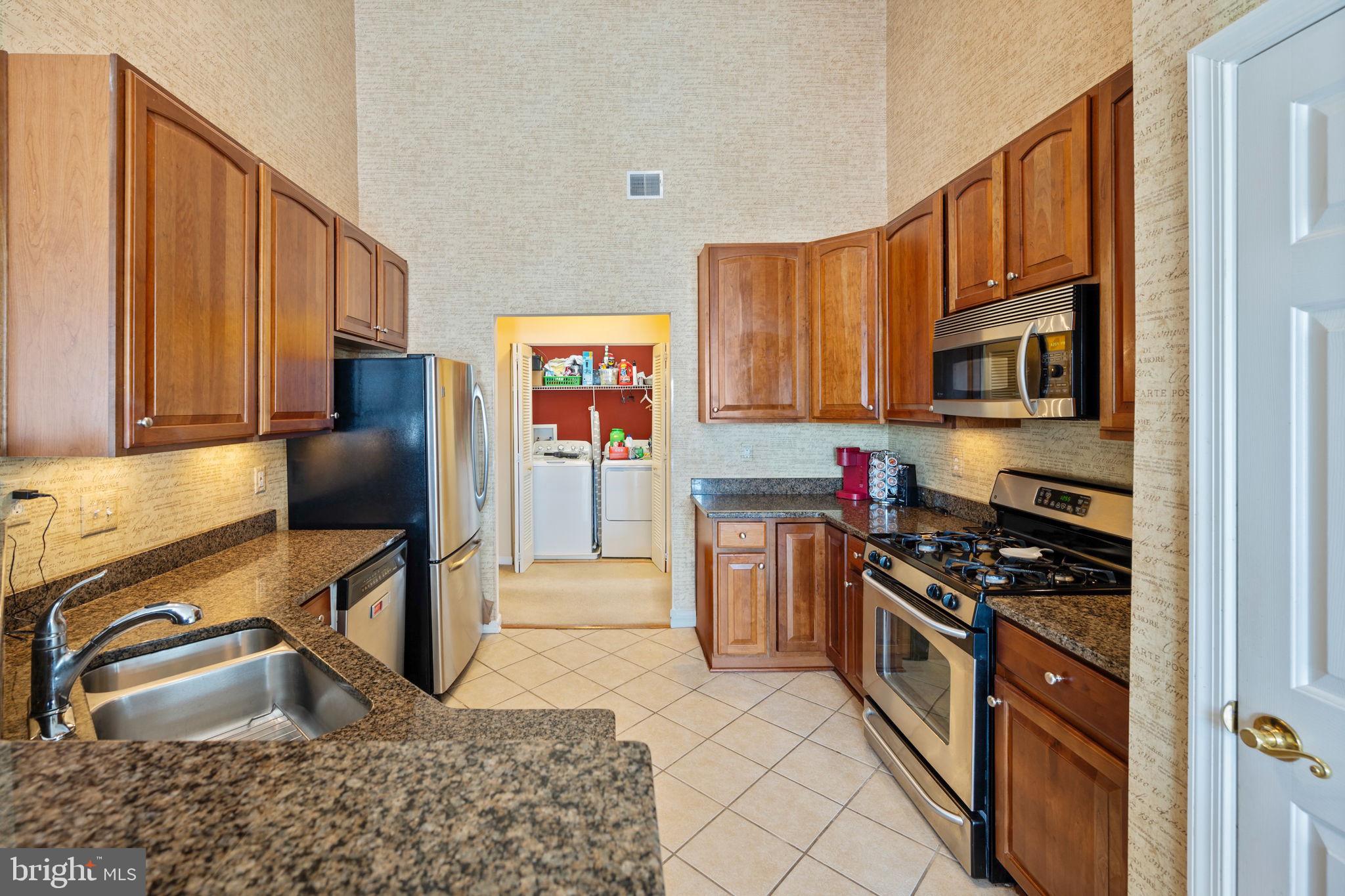 2602 Clarion Court, Unit 404 Odenton, MD 21113 - Photo 15 of 38 a kitchen with stainless steel appliances granite countertop a sink stove and cabinets