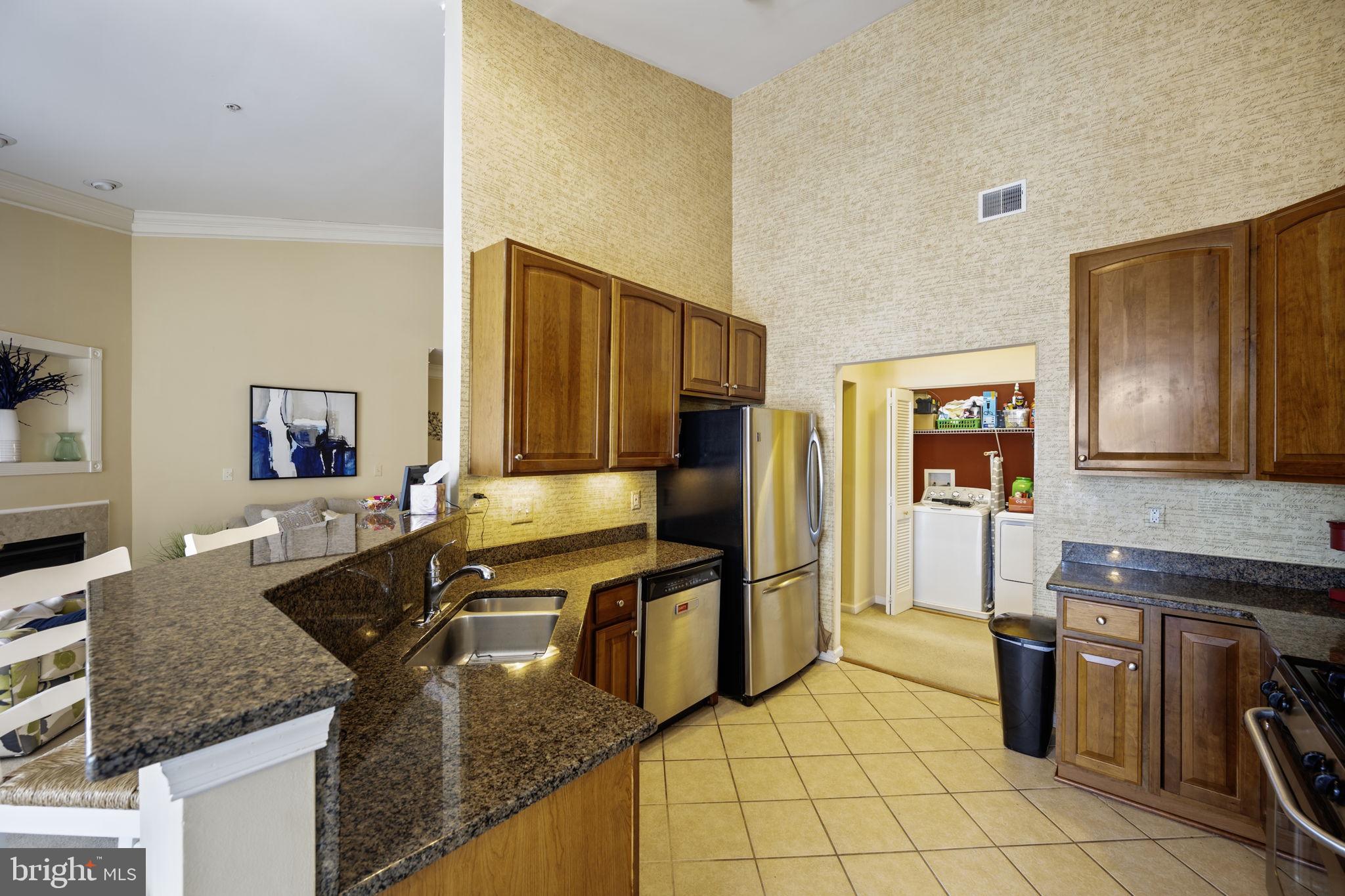 2602 Clarion Court, Unit 404 Odenton, MD 21113 - Photo 18 of 38 a kitchen with granite countertop a sink stove and refrigerator