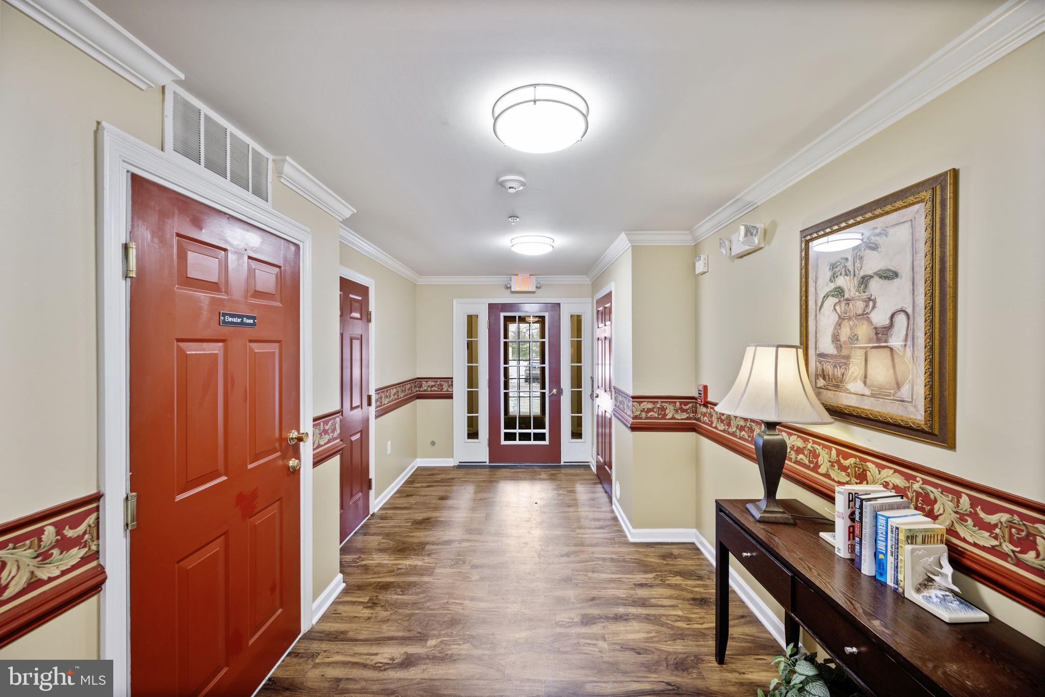 2602 Clarion Court, Unit 404 Odenton, MD 21113 - Photo 2 of 38 a view of a hallway with furniture and wooden floor