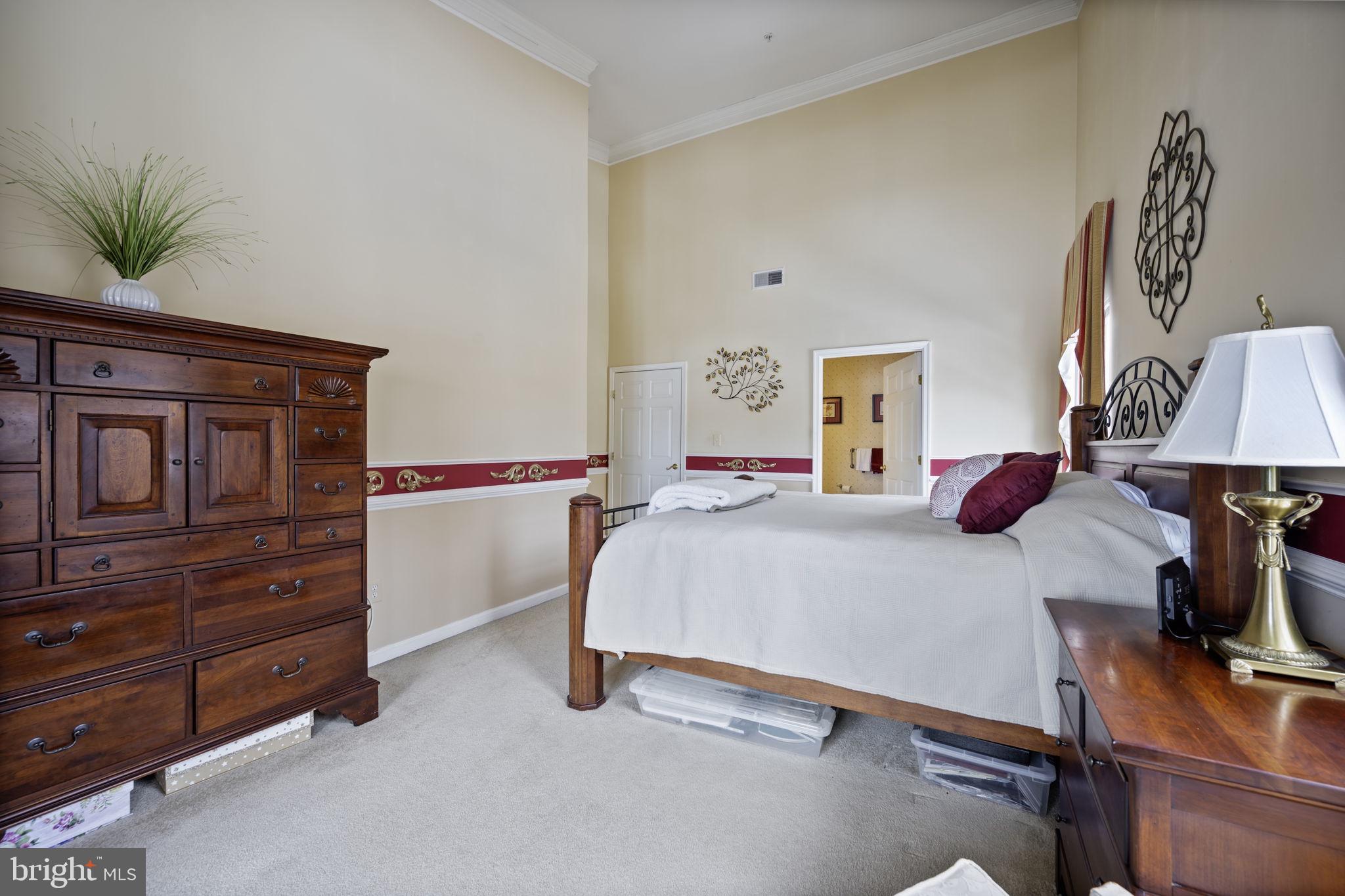 2602 Clarion Court, Unit 404 Odenton, MD 21113 - Photo 23 of 38 a bedroom with a bed and furniture