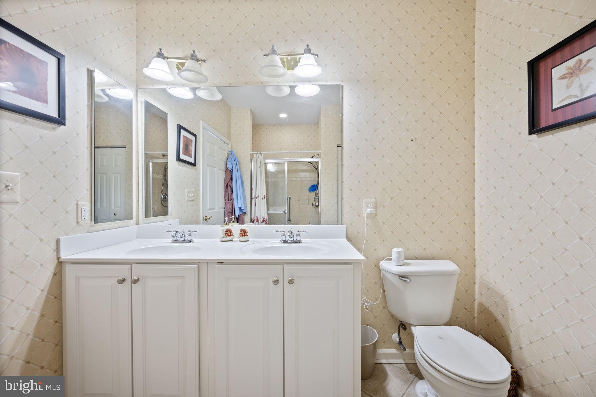 2602 Clarion Court, Unit 404 Odenton, MD 21113 - Photo 29 of 38 a bathroom with a toilet sink and mirror