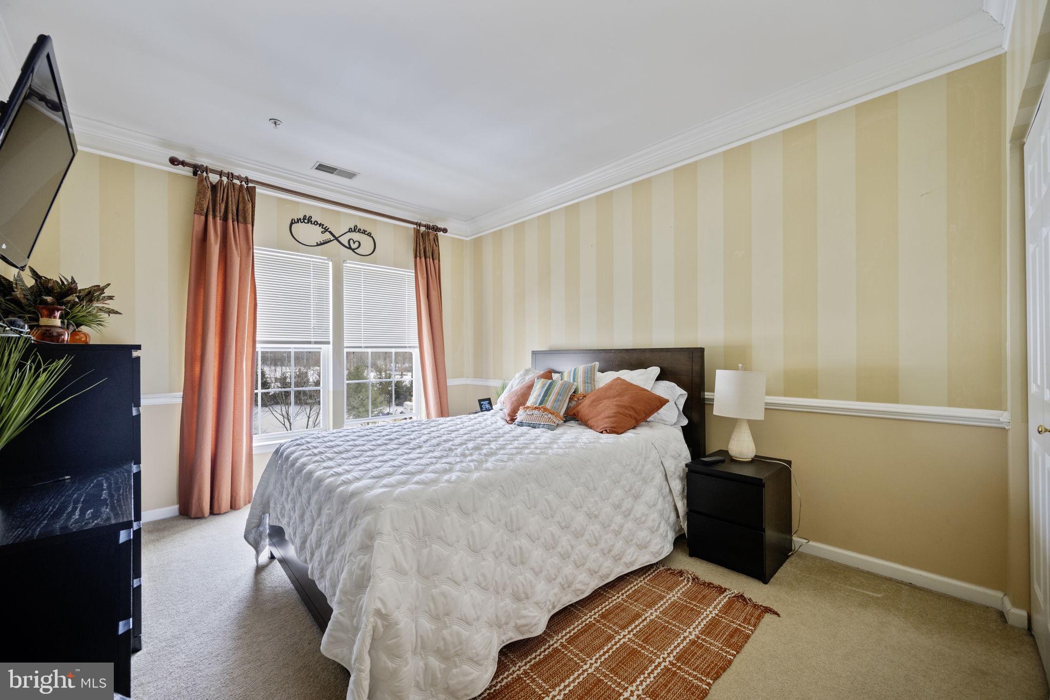 2602 Clarion Court, Unit 404 Odenton, MD 21113 - Photo 30 of 38 a bedroom with a bed and a window