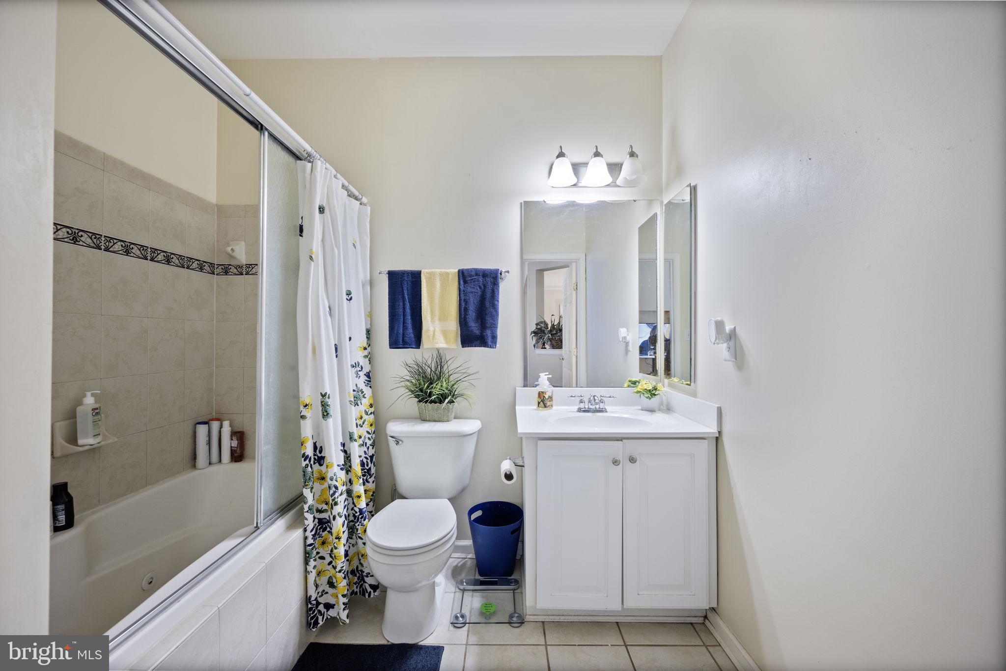 2602 Clarion Court, Unit 404 Odenton, MD 21113 - Photo 33 of 38 a spacious bathroom with a bathtub shower sink mirror and toilet