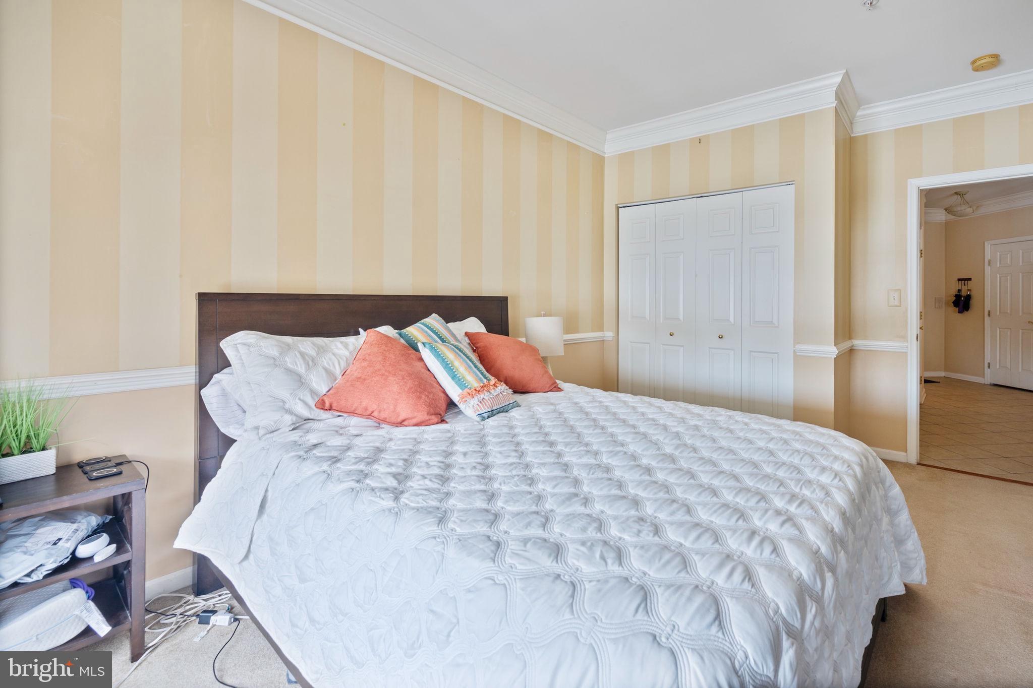 2602 Clarion Court, Unit 404 Odenton, MD 21113 - Photo 34 of 38 a bedroom with a bed and a table in it