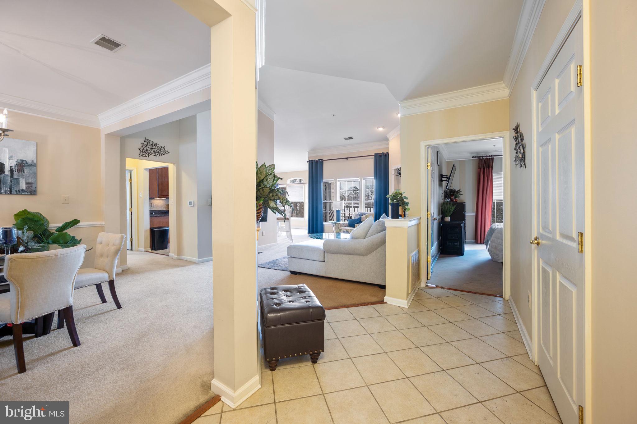 2602 Clarion Court, Unit 404 Odenton, MD 21113 - Photo 4 of 38 a living room with furniture and a dining table
