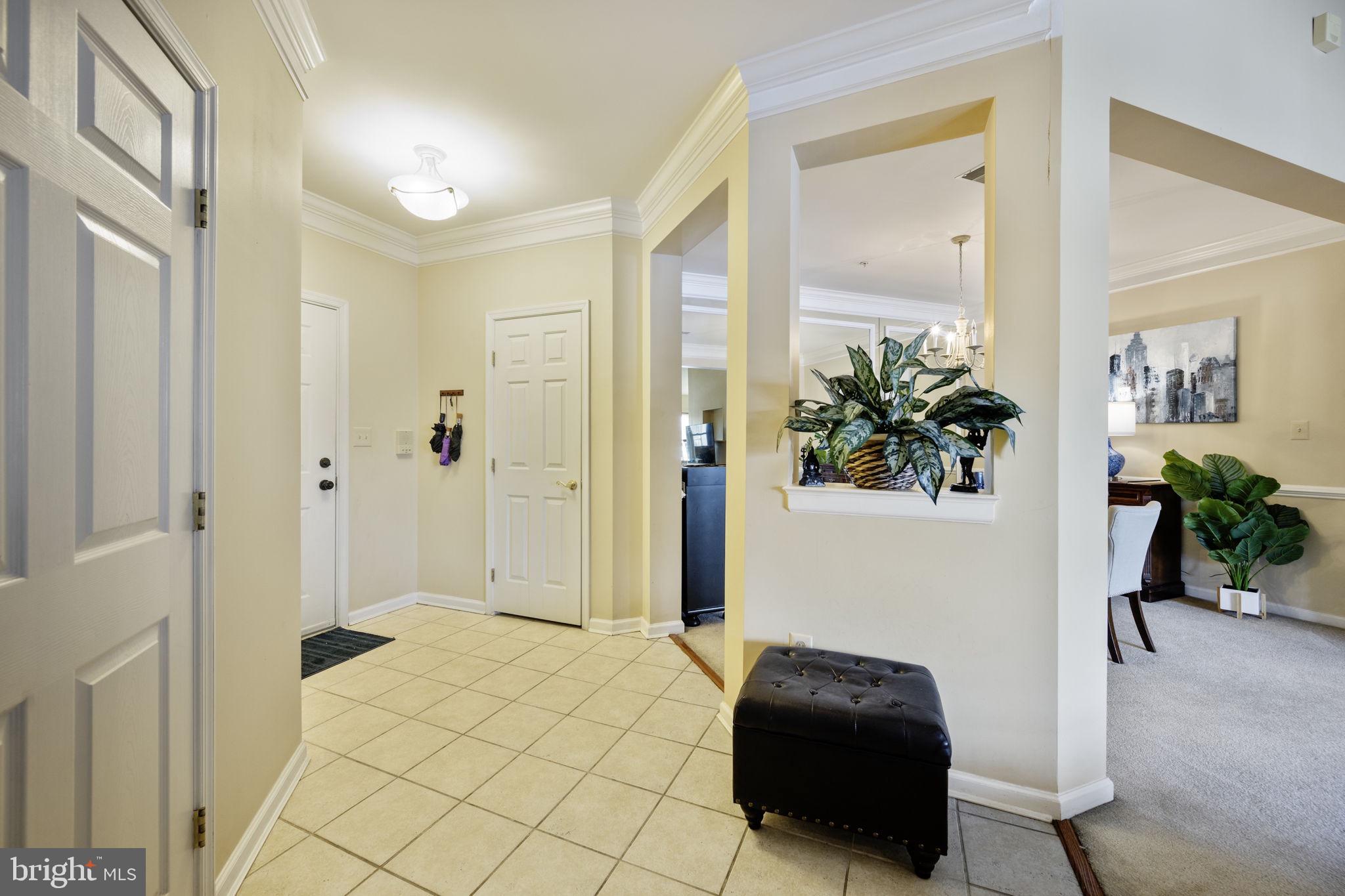 2602 Clarion Court, Unit 404 Odenton, MD 21113 - Photo 5 of 38 a bedroom with a bed and a potted plant
