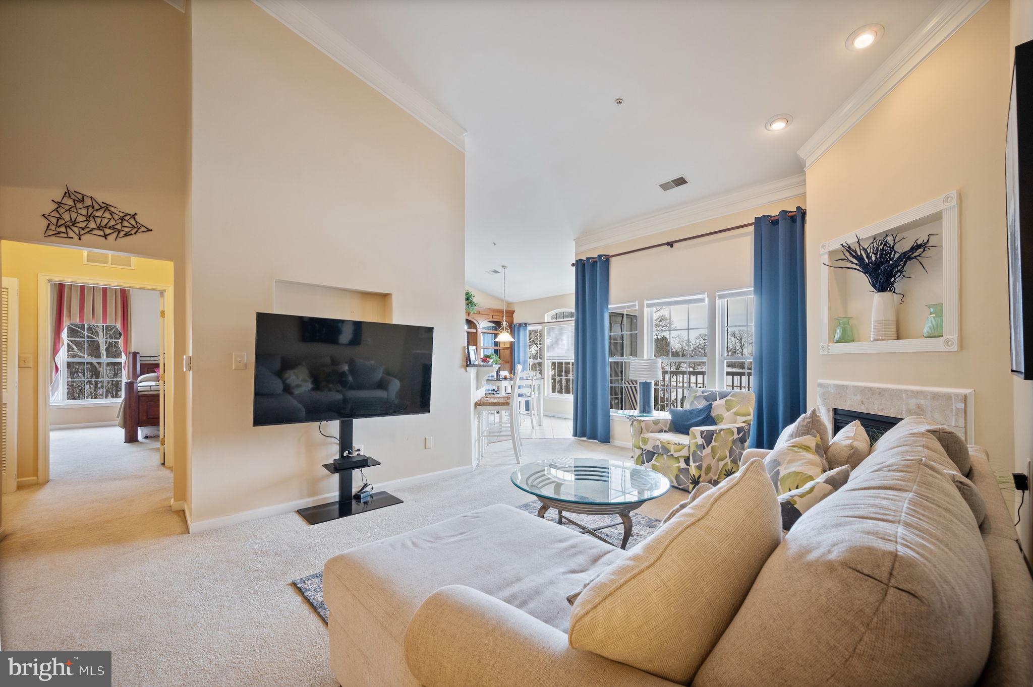 2602 Clarion Court, Unit 404 Odenton, MD 21113 - Photo 7 of 38 a living room with furniture and a flat screen tv
