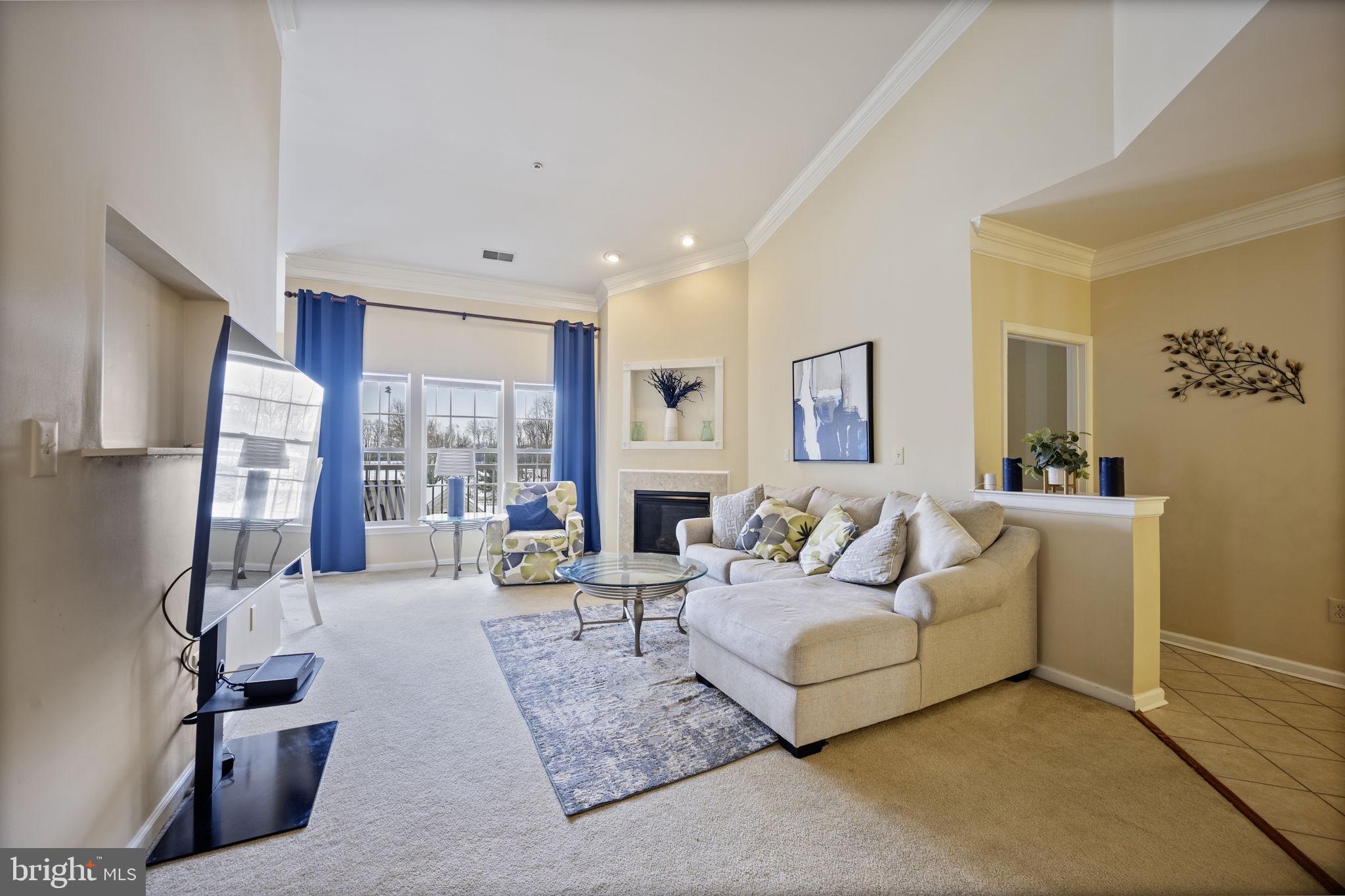 2602 Clarion Court, Unit 404 Odenton, MD 21113 - Photo 8 of 38 a living room with fireplace furniture and a large window
