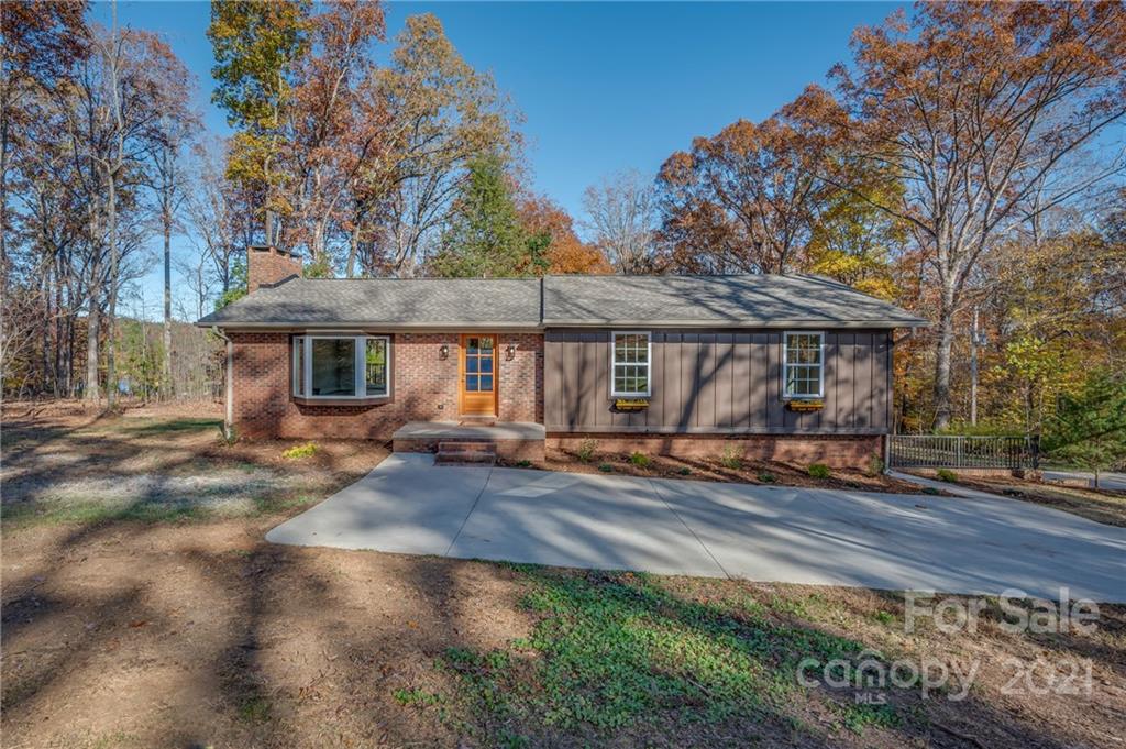 438 Gilbert Road Columbus, NC 28722 - Photo 1 of 46 a front view of a house with a yard