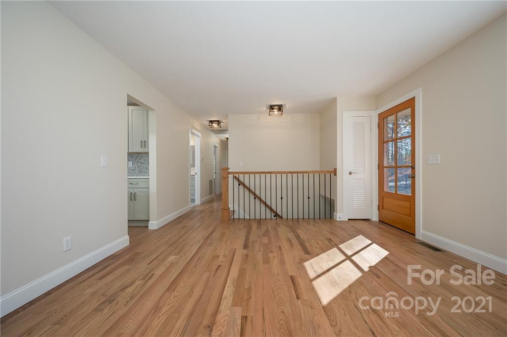 438 Gilbert Road Columbus, NC 28722 - Photo 12 of 46 a view of a hallway with wooden floor