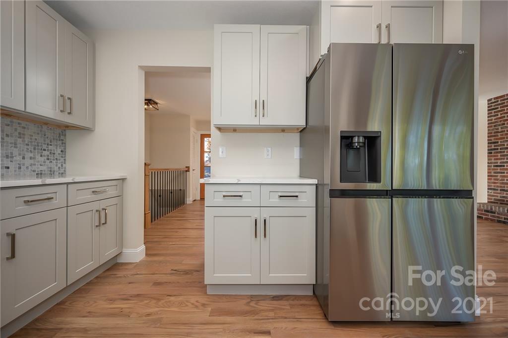438 Gilbert Road Columbus, NC 28722 - Photo 15 of 46 a kitchen with stainless steel appliances a refrigerator and cabinets