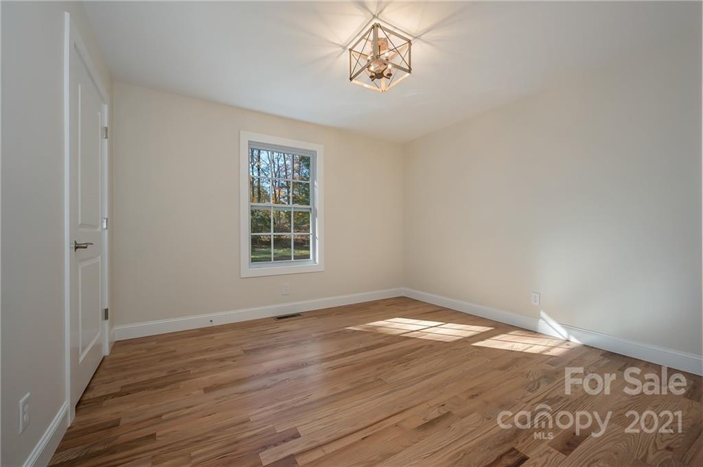 438 Gilbert Road Columbus, NC 28722 - Photo 16 of 46 a view of empty room with wooden floor