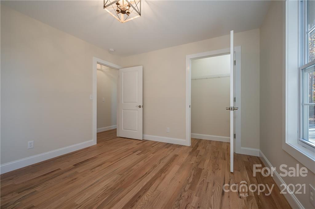 438 Gilbert Road Columbus, NC 28722 - Photo 17 of 46 an empty room with wooden floor and windows