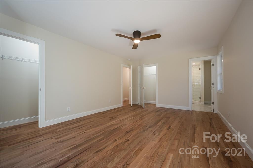 438 Gilbert Road Columbus, NC 28722 - Photo 20 of 46 a view of empty room with wooden floor and ceiling fan