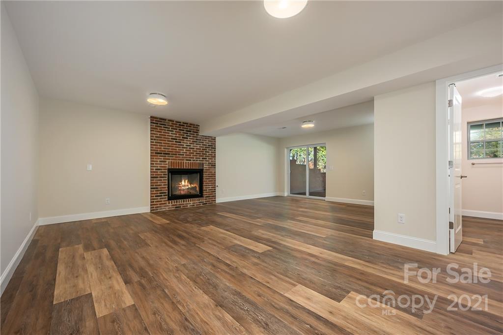 438 Gilbert Road Columbus, NC 28722 - Photo 25 of 46 a view of empty room with wooden floor and fireplace