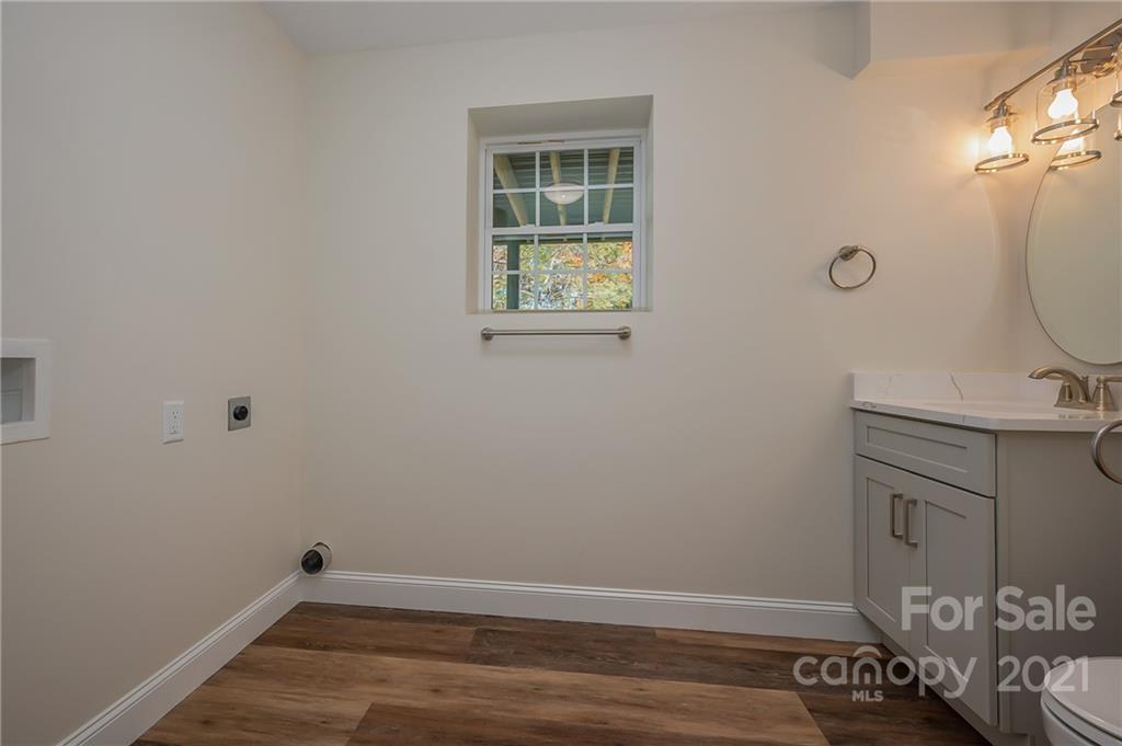 438 Gilbert Road Columbus, NC 28722 - Photo 32 of 46 a view of a bathroom with sink and wooden floor