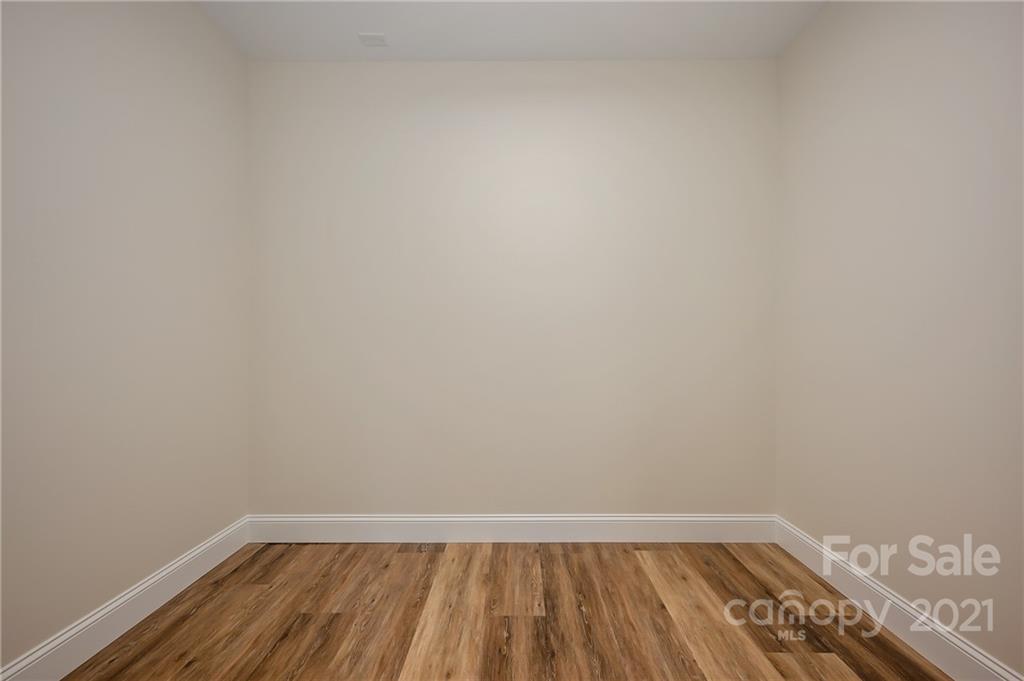 438 Gilbert Road Columbus, NC 28722 - Photo 35 of 46 a view of an empty room with wooden floor