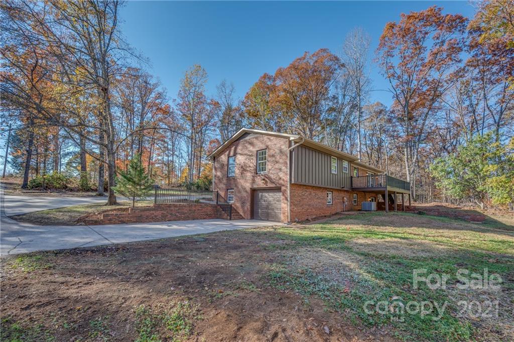 438 Gilbert Road Columbus, NC 28722 - Photo 40 of 46 a view of a yard with a house in the background
