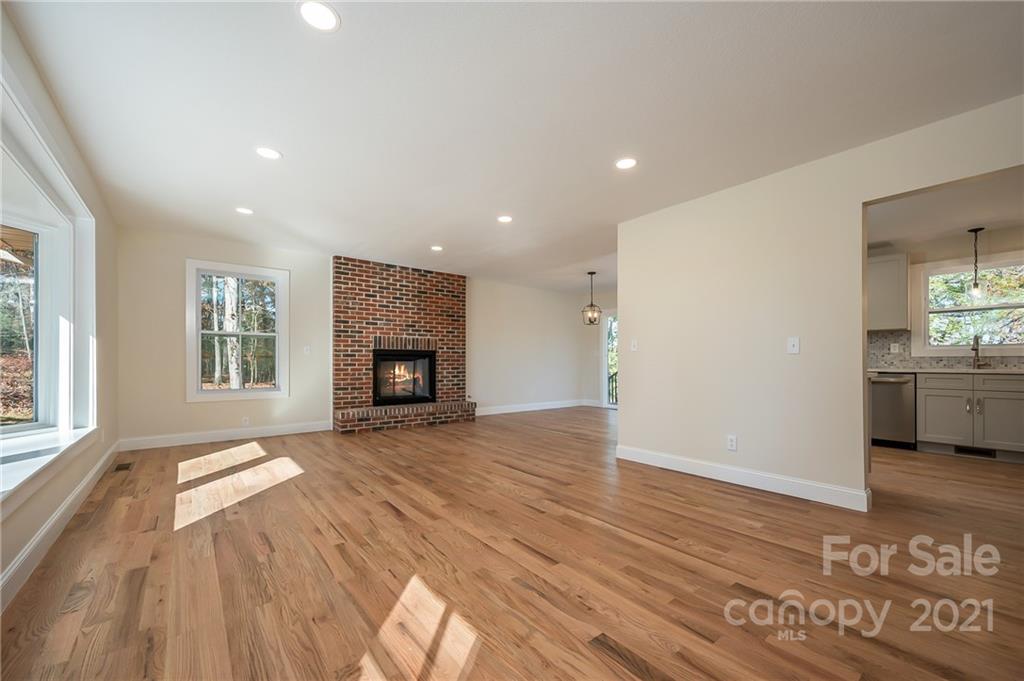 438 Gilbert Road Columbus, NC 28722 - Photo 5 of 46 a view of an empty room with a window and fire place