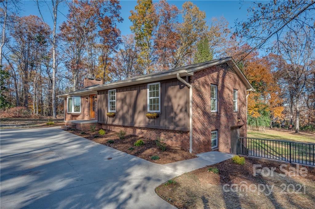 438 Gilbert Road Columbus, NC 28722 - Photo 45 of 46 a backyard of a house with barbeque oven table and chairs