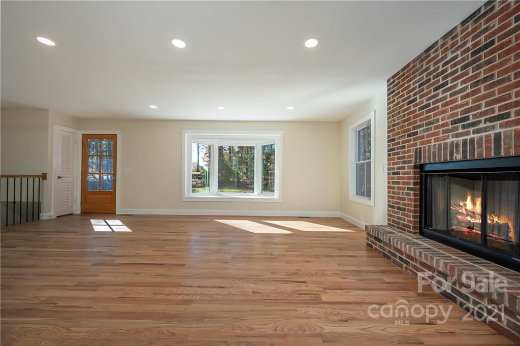 438 Gilbert Road Columbus, NC 28722 - Photo 7 of 46 a view of an empty room with window and fire place