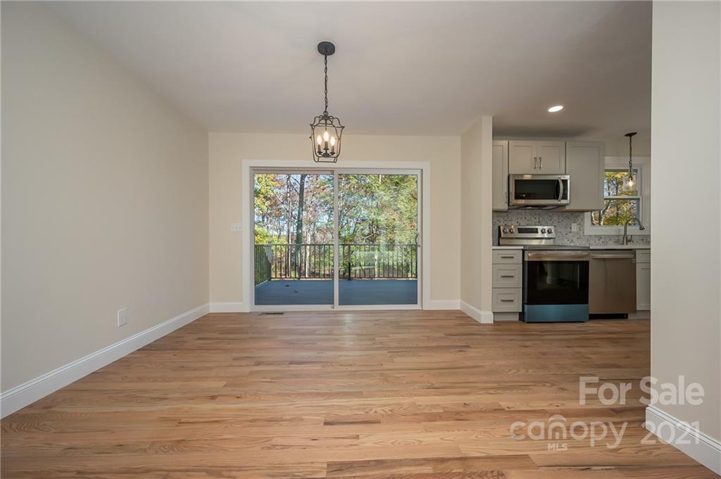 438 Gilbert Road Columbus, NC 28722 - Photo 8 of 46 a view of an empty room with a fireplace and a window