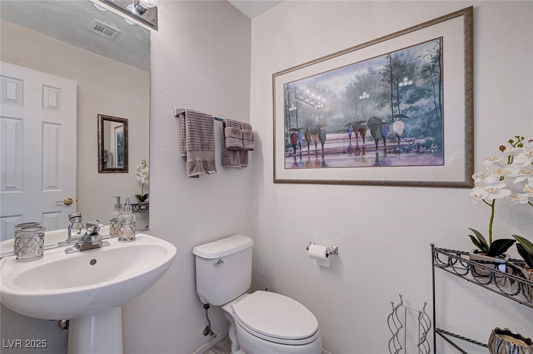 516 Crimson View Place Las Vegas, NV 89144 - Photo 15 of 66 Half bath featuring a textured wall and tile patterned floors