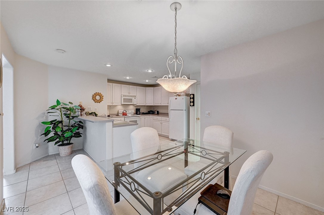 516 Crimson View Place Las Vegas, NV 89144 - Photo 18 of 66 Dining room featuring light tile patterned flooring and recessed lighting