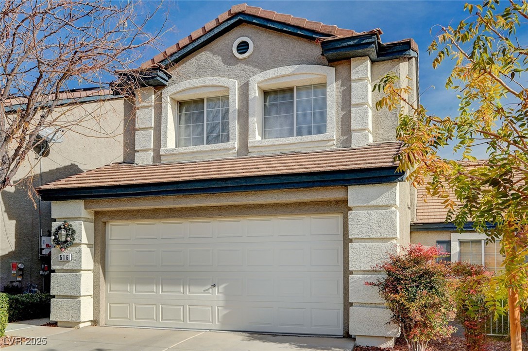 516 Crimson View Place Las Vegas, NV 89144 - Photo 2 of 66 View of front of home featuring a tile roof, stucco siding, an attached garage, and concrete driveway