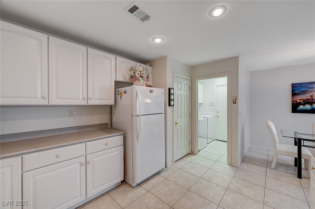 516 Crimson View Place Las Vegas, NV 89144 - Photo 24 of 66 Kitchen featuring white cabinetry, freestanding refrigerator, light countertops, light tile patterned floors, and recessed lighting