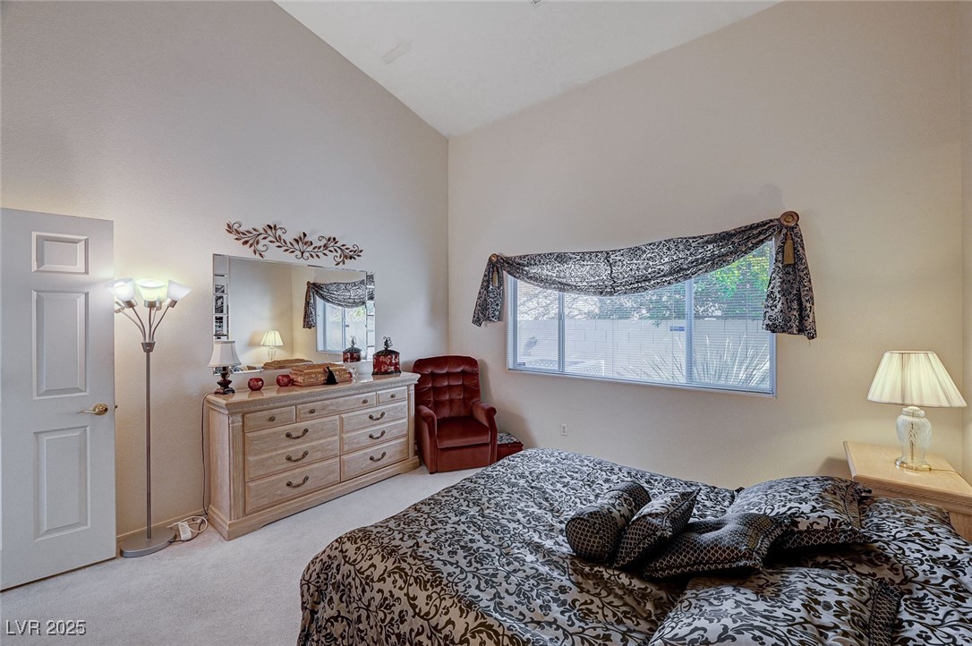 516 Crimson View Place Las Vegas, NV 89144 - Photo 27 of 66 Bedroom featuring light carpet and lofted ceiling