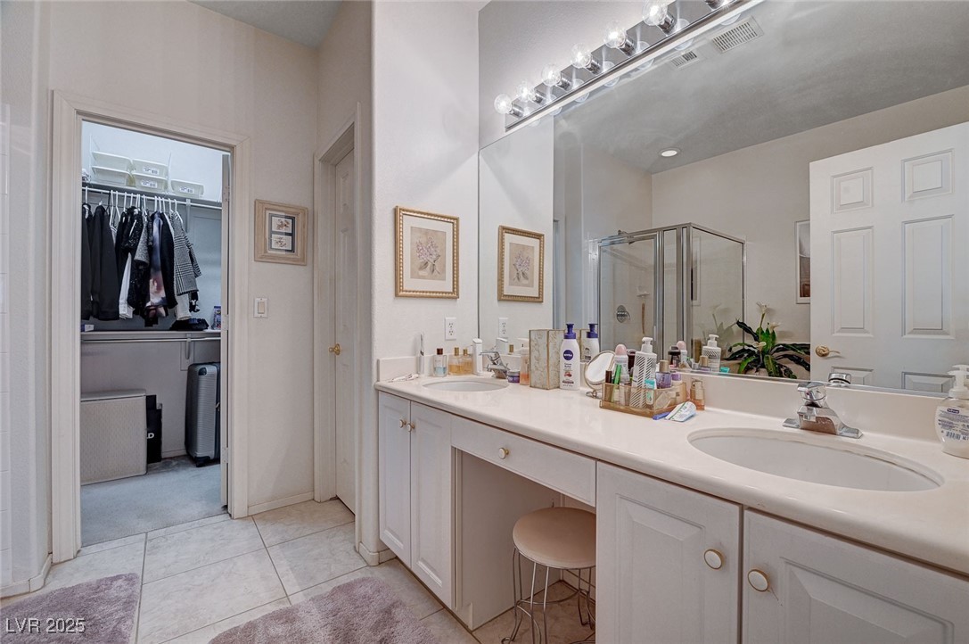516 Crimson View Place Las Vegas, NV 89144 - Photo 30 of 66 Full bath featuring a spacious closet, light tile patterned flooring, a shower stall, and double vanity