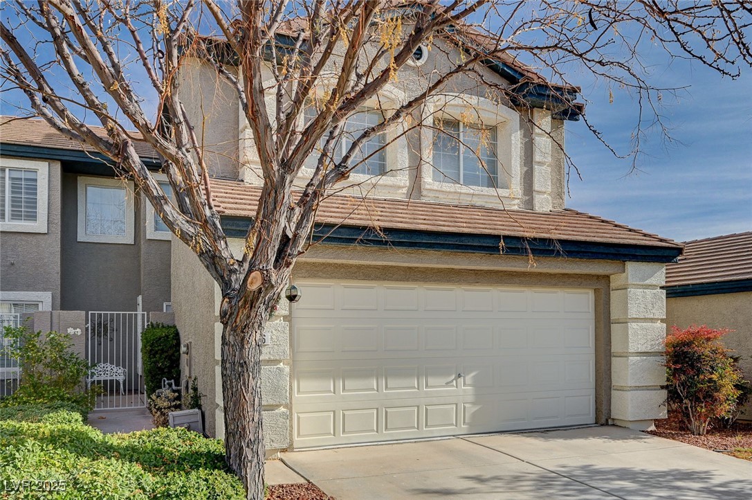 516 Crimson View Place Las Vegas, NV 89144 - Photo 3 of 66 Traditional home with stucco siding, a garage, a tile roof, and driveway