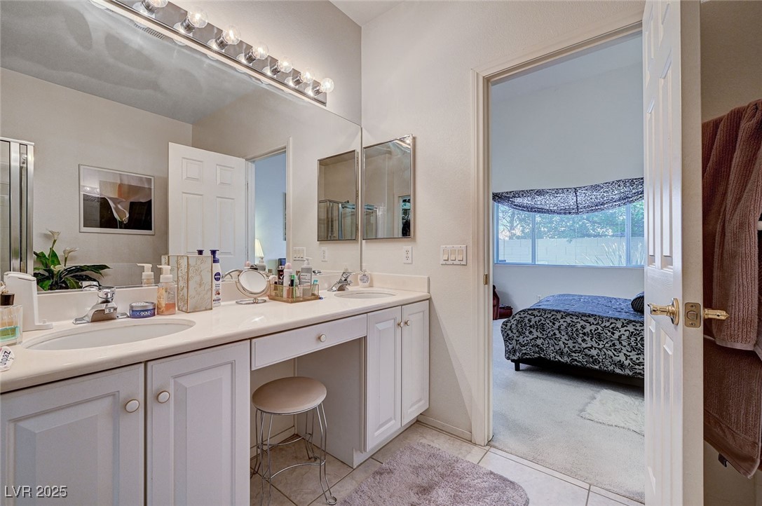 516 Crimson View Place Las Vegas, NV 89144 - Photo 31 of 66 Ensuite bathroom featuring double vanity, light tile patterned floors, and light carpet