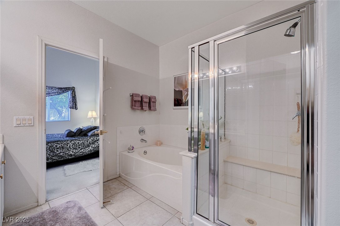 516 Crimson View Place Las Vegas, NV 89144 - Photo 32 of 66 Ensuite bathroom with light tile patterned floors, a bath, a shower stall, and vanity