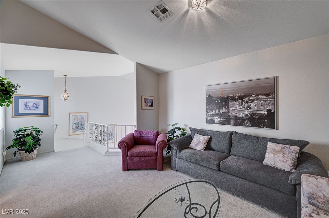 516 Crimson View Place Las Vegas, NV 89144 - Photo 39 of 66 Living area with carpet floors and vaulted ceiling