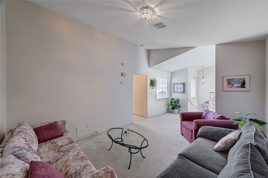 516 Crimson View Place Las Vegas, NV 89144 - Photo 40 of 66 Living area featuring lofted ceiling and light colored carpet