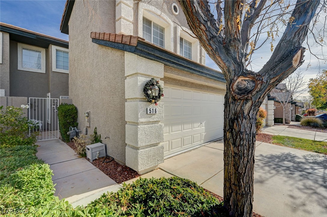 516 Crimson View Place Las Vegas, NV 89144 - Photo 4 of 66 Garage with a gate and concrete driveway