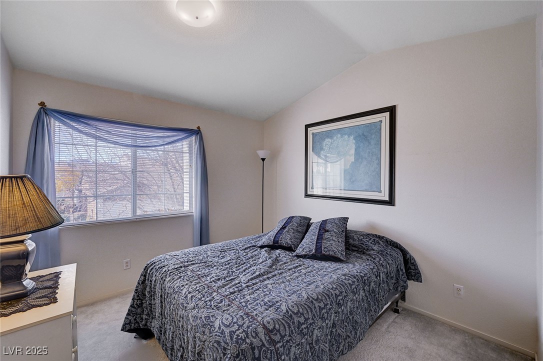 516 Crimson View Place Las Vegas, NV 89144 - Photo 41 of 66 Carpeted bedroom with vaulted ceiling and baseboards