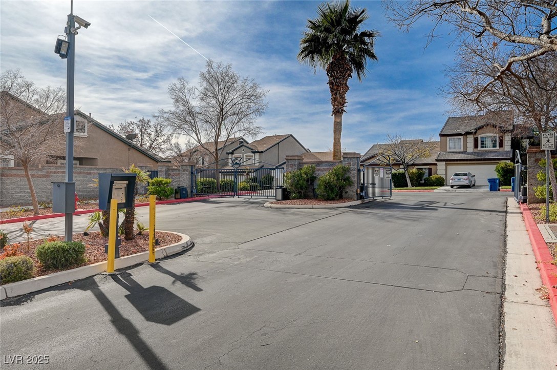 516 Crimson View Place Las Vegas, NV 89144 - Photo 50 of 66 View of asphalt road with curbs, a gate, a residential view, and a gated entry