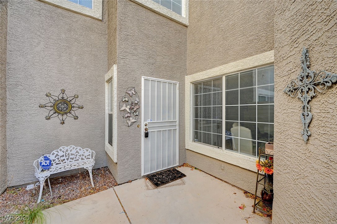 516 Crimson View Place Las Vegas, NV 89144 - Photo 5 of 66 Doorway to property with stucco siding and a patio