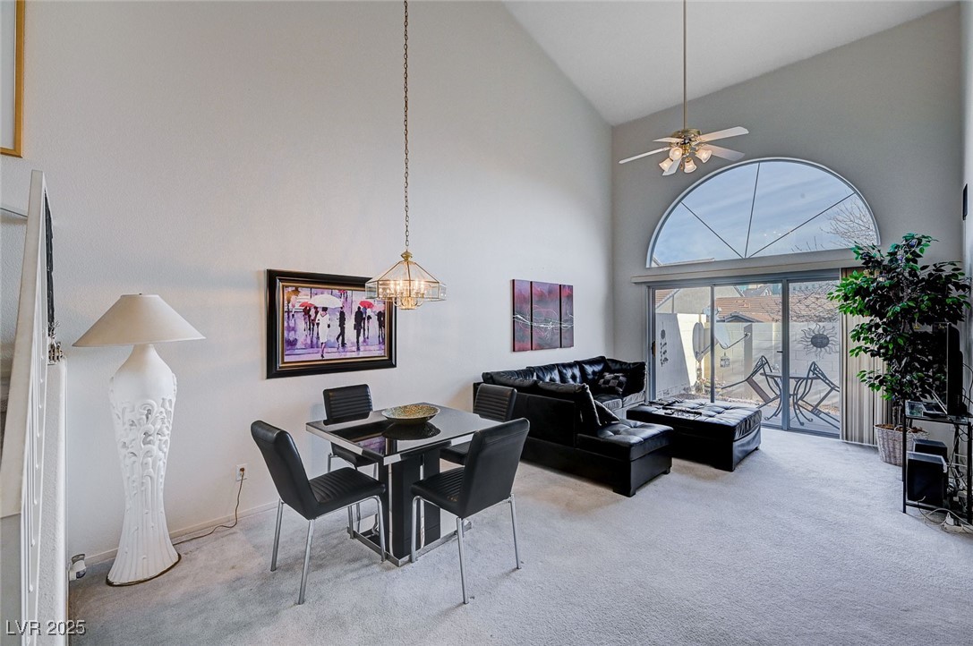 516 Crimson View Place Las Vegas, NV 89144 - Photo 8 of 66 Dining space with high vaulted ceiling, carpet, ceiling fan, and a chandelier