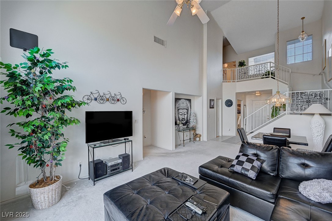 516 Crimson View Place Las Vegas, NV 89144 - Photo 10 of 66 Living area featuring carpet, a towering ceiling, stairway, and a ceiling fan