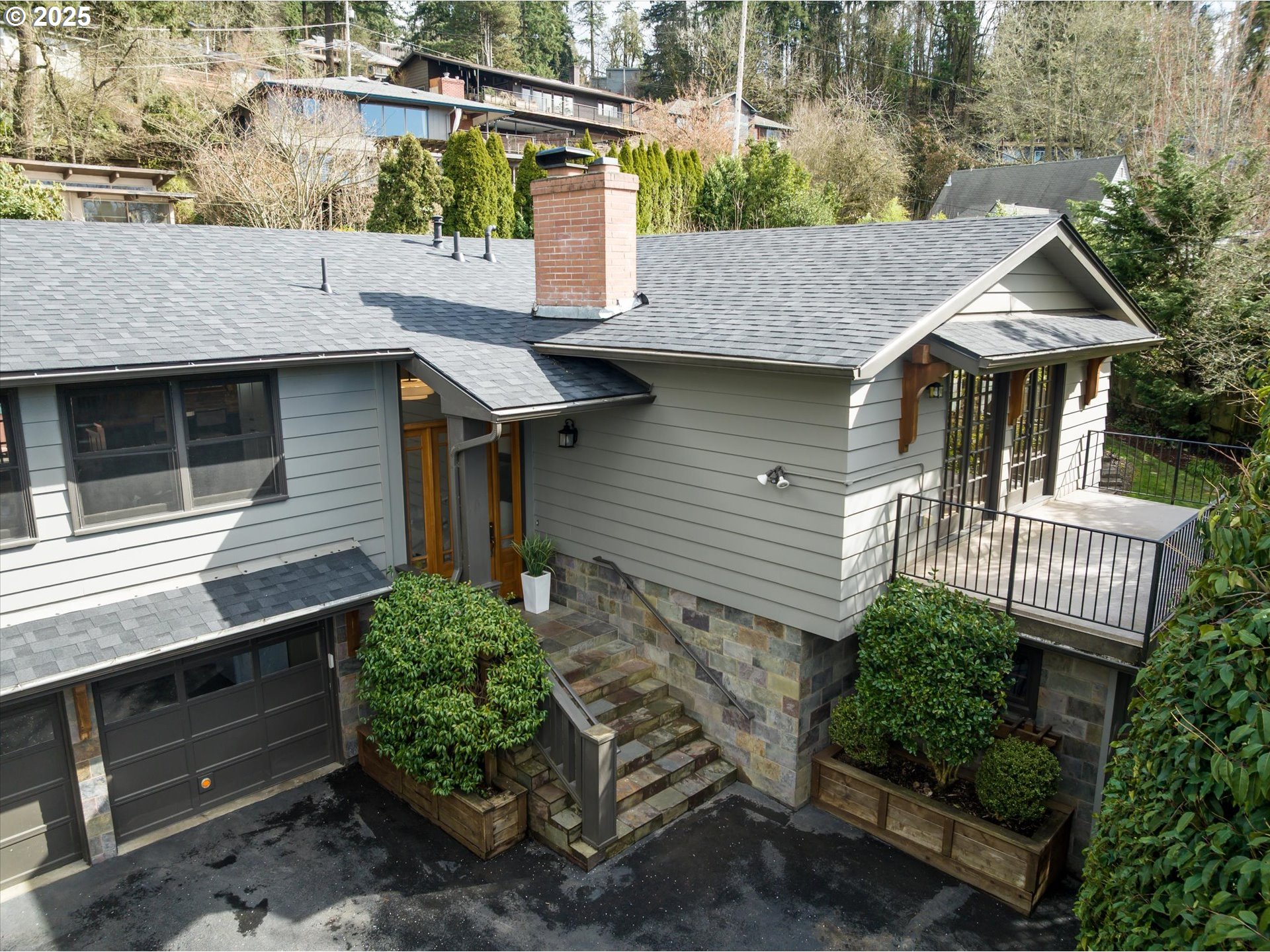 a view of a house with a yard and potted plants