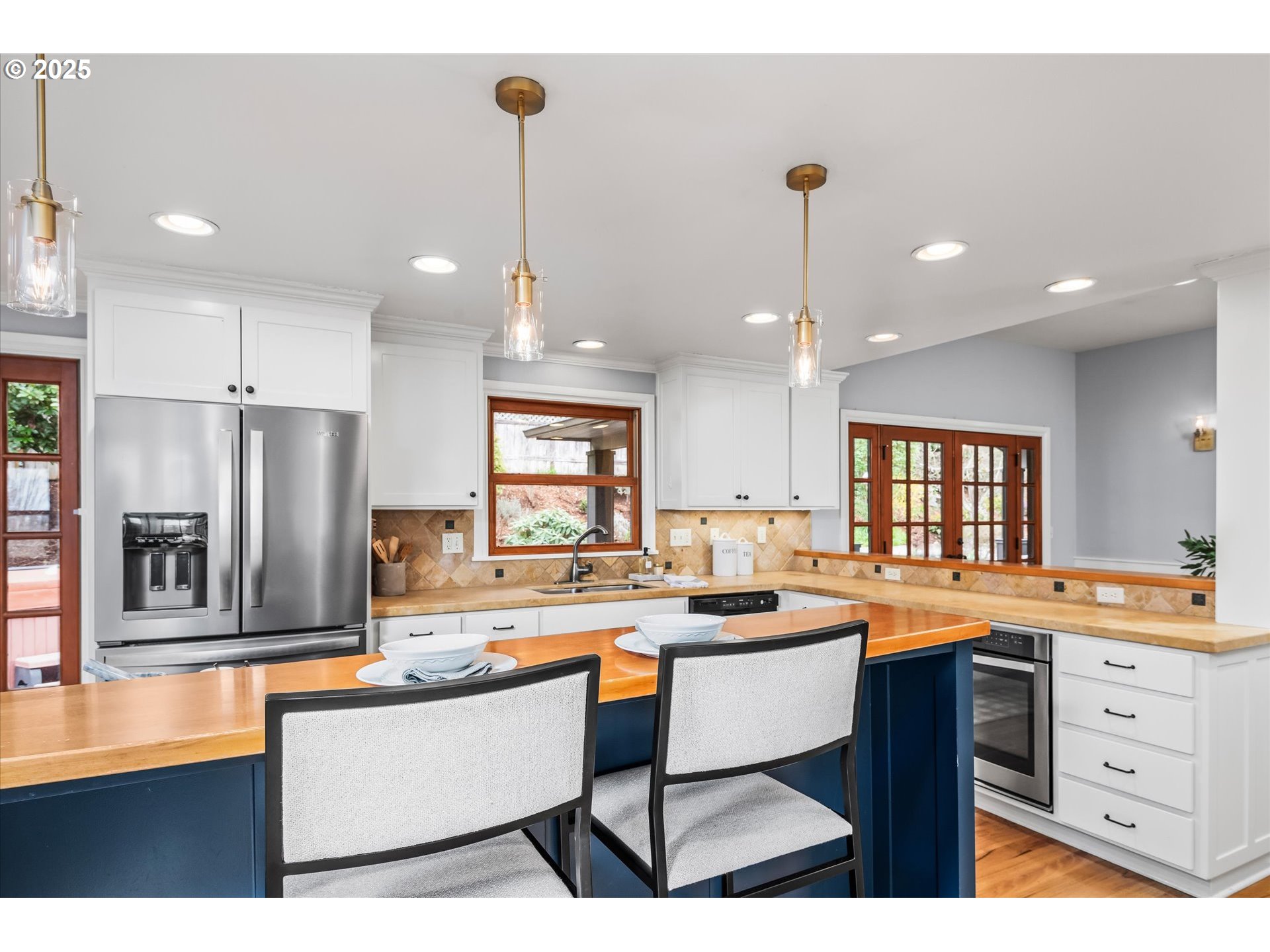 1705 Fairmount Boulevard Eugene, OR 97403 - Photo 16 of 48 a kitchen with a refrigerator a sink dishwasher a oven and a dining table with wooden floor